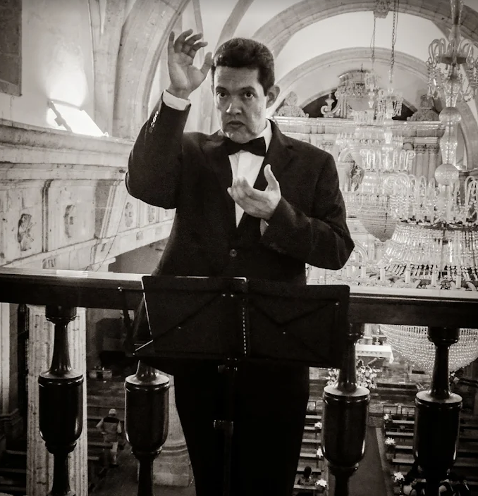 Director de Coro y Orquesta Interclásico dirigiendo en una presentación profesional